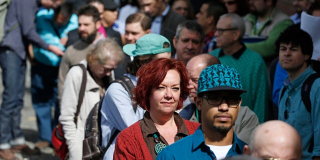 Job seekers line up to attend a job fair in Downtown Denver.