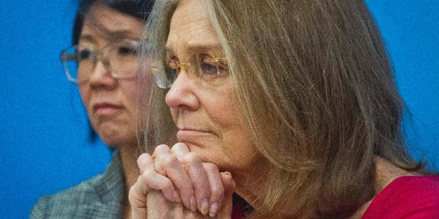 Organizers of the effort called WomenCrossDMZ.org, including honorary co-chair Gloria Steinem, right, and lead coordinator Christine Ahn, left, listen during a United Nations news conference announcing plans for a rare and risky women's walk across the demilitarized zone between North and South Korea to call for reunification, Wednesday, March 11, 2015. (AP Photo/Bebeto Matthews)