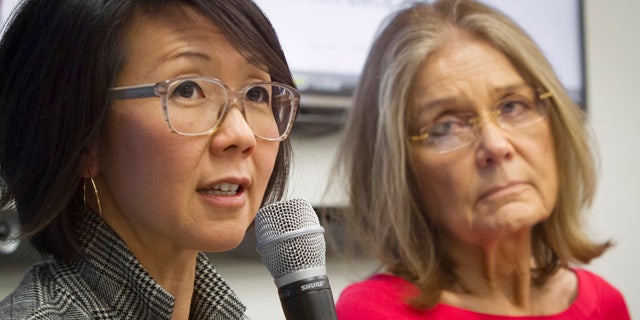 FILE - Organizers of the effort called WomenCrossDMZ.org, including lead coordinator Christine Ahn, left, and honorary co-chair Gloria Steinem, right, hold a United Nations news conference announcing plans for a rare and risky women's walk across the demilitarized zone between North and South Korea to call for reunification, in this March 11, 2015 file photo. (AP Photo/Bebeto Matthews, File)