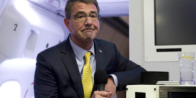 FILE - In this Wednesday, July 22, 2015, file photo, U.S. Defense Secretary Ash Carter pauses as he speaks with media on a military aircraft after departing Jiddah, Saudi Arabia, en route to Amman, Jordan. (AP Photo/Carolyn Kaster, Pool, File)