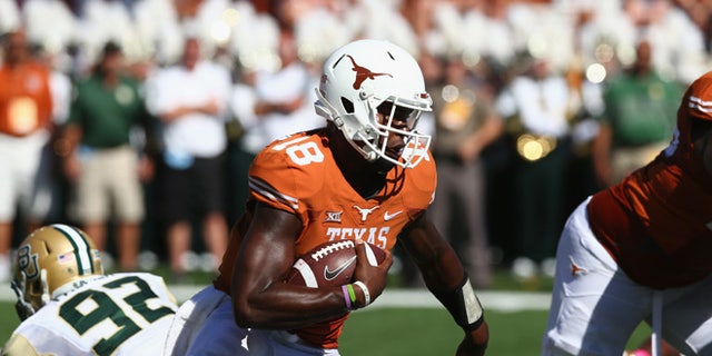 AUSTIN, TX - OCTOBER 04:  Tyrone Swoopes #18 of the Texas Longhorns runs the ball against the Baylor Bears at Darrell K Royal-Texas Memorial Stadium on October 4, 2014 in Austin, Texas.  (Photo by Ronald Martinez/Getty Images)