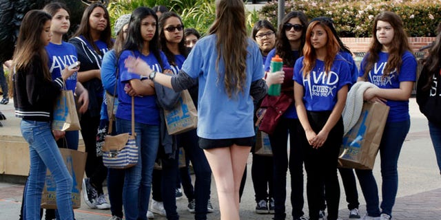 Feb. 26, 2015: UCLA campus tour guide Samantha St. Germain, a bioengineering student, middle, leads prospective college-bound high school seniors on a campus tour in Los Angeles.