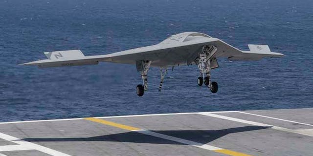 July 10, 2013: A X47-B Navy drone approaches the deck as it lands aboard the nuclear aircraft carrier USS George H. W. Bush off the Coast of Virginia.