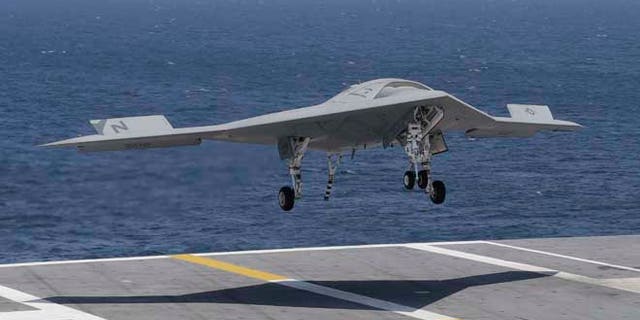 July 10, 2013: A X47-B Navy drone approaches the deck as it lands aboard the nuclear aircraft carrier USS George H. W. Bush off the Coast of Virginia.