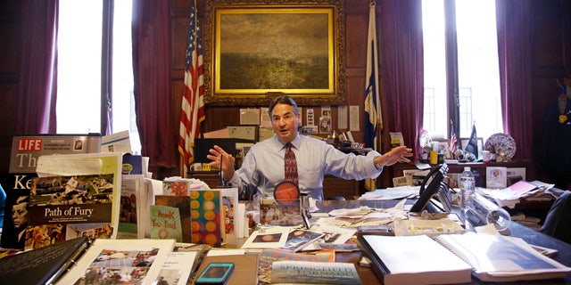 June 5, 2014: Springfield Mayor Domenic Sarno sits behind his city hall desk reiterating the position he has taken with the United States State Department against accepting any more resettled refugees in Springfield, Mass. (AP Photo/Stephan Savoia)