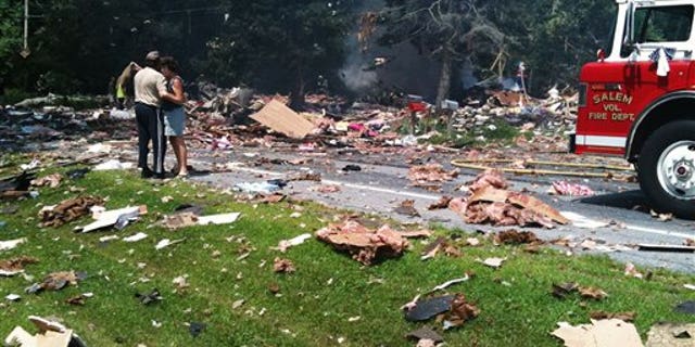 July 13: Landlords David and Linda Baldwin embrace amid the debris of their rental home after it exploded on Route 29 1/2 mile west of the intersection with Route 22 in Salem, N.Y.