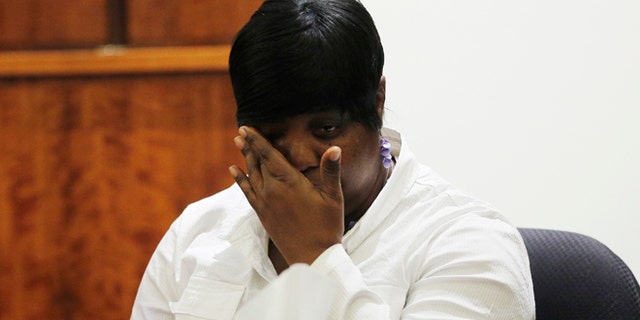 Ursula Ward, mother of Odin Lloyd, wipes her eyes after looking at a photograph from the medical examiner's office of her dead son during the murder trial of former NFL football player Aaron Hernandez at Bristol County Superior Court in Fall River, Mass., Wednesday, Feb. 4, 2015. Hernandez is accused of the June 2013 killing of Lloyd. (AP Photo/Brian Snyder, Pool)