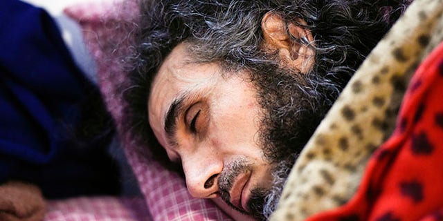 FILE - In this Sept. 9, 2016 file photo, Syrian native Abu Wa'el Dhiab rests in bed while conversing with his family via a laptop, in his apartment in Montevideo, Uruguay. An Uruguayan official said on Sept. 14 that the health of the resettled former Guantanamo detainee has taken a turn for the worse due to a hunger strike he launched to demand relocation to another country. He says he no longer wants to remain in Uruguay and would like to join his wife and daughters in Turkey. Uruguayan officials say they are trying to find another country to accept him. (AP Photo/Matilde Campodonico, File)