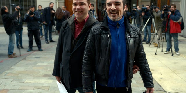 Rodrigo Borda and his partner Sergio Miranda leave the Civil Registry office where they signed up to marry in Montevideo, Uruguay, Monday, Aug. 5, 2013.