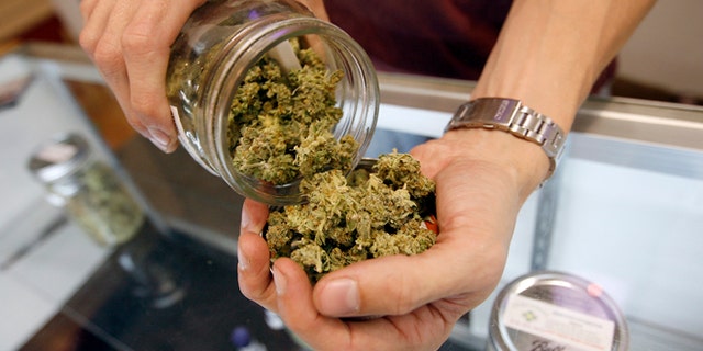 LOS ANGELES, CA - JULY 25: A budtender pours marijuana from a jar at Perennial Holistic Wellness Center medical marijuana dispensary, which opened in 2006, on July 25, 2012 in Los Angeles, California. The Los Angeles City Council has unanimously voted to ban storefront medical marijuana dispensaries and to order them to close or face legal action. The council also voted to instruct staff to draw up a separate ordinance for consideration in about three months that might allow dispensaries that existed before a 2007 moratorium on new dispensaries to continue to operate. It is estimated that Los Angeles has about one thousand such facilities. The ban does not prevent patients or cooperatives of two or three people to grow their own in small amounts. Californians voted to legalize medical cannabis use in 1996, clashing with federal drug laws. The state Supreme Court is expected to consider ruling on whether cities can regulate and ban dispensaries. (Photo by David McNew/Getty Images)