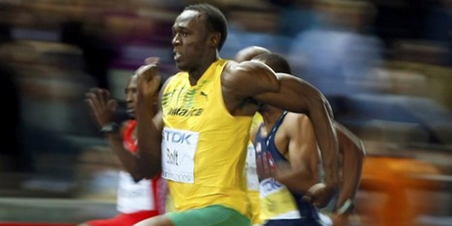 Usain Bolt of Jamaica sprints to the finish to win in the men's 100 meters final during the world athletics championships at the Olympic stadium in Berlin.