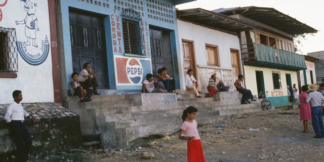 A young girl stands on the side of the road towards the El Ceibal Ruins, Guatemala City, November 1988 (Photo by Frances M. Ginter/Getty Images)