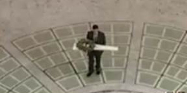 Oct. 15, 2015: This image shows an unidentified man carrying a package containing an unloaded rifle into Utah's state capitol building in Salt Lake City. (Utah Department of Public Safety)