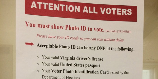 The new state rules are posted prominently at the Lee Center in Alexandria, Va., where the state began checking photo identification for registered voters on Tuesday, Nov. 4, 2014. (Julie Moos/McClatchyDC)
