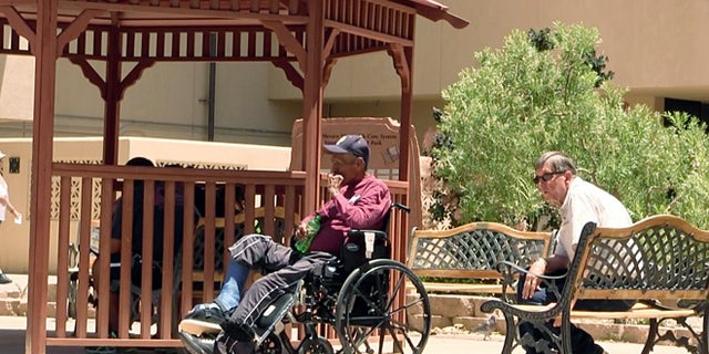 Men sit outside the Raymond G. Murphy VA Medical Center in Albuquerque, New Mexico, in July 2014.
