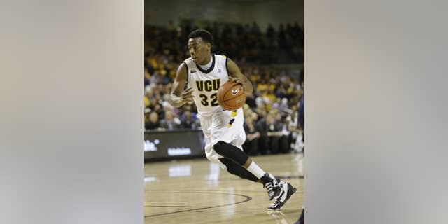FILE - In this March 6, 2013, file photo, VCU guard Melvin Johnson (32) drives to the basket during the first half of an NCAA college basketball game in Richmond, Va. (AP Photo/Steve Helber, Fille)