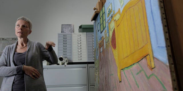 August 27: Restorer Ella Hendriks comments on the restoration of Vincent Van Gogh's 'The Bedroom' painting, right on easel, at the Van Gogh museum in Amsterdam, Netherlands. (AP)