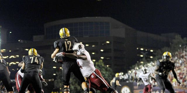 Sep 20, 2014; Nashville, TN, USA; Vanderbilt Commodores quarterback Wade Freebeck (12) is hit as he passes the ball during the first half against the South Carolina Gamecocks at Vanderbilt Stadium. Mandatory Credit: Christopher Hanewinckel-USA TODAY Sports