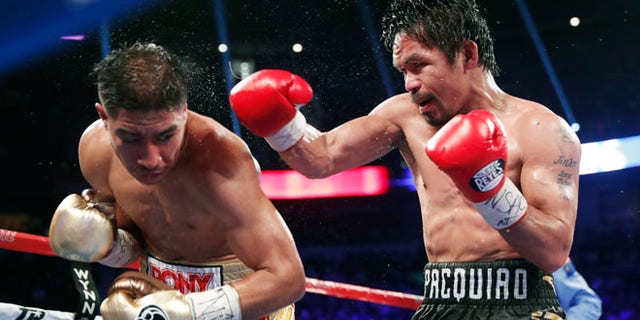 Jessie Vargas, left, tries to avoid a punch from Manny Pacquiao, of the Philippines, during their WBO welterweight title boxing match, Saturday, Nov. 5, 2016, in Las Vegas. (AP Photo/Isaac Brekken)