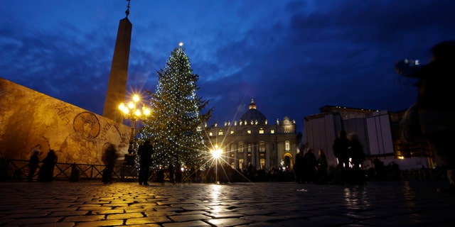 The 24 meters (78.74 feet) Christmas tree is lit in St. Peter's square at the Vatican, Friday, Dec. 14, 2012. The Christmas season kicks off Friday at the Vatican with the traditional lighting of the tree in St. Peter's Square and a reminder from the Pope about what happened when the "lights" of God were turned off in past atheistic regimes. (AP Photo/Gregorio Borgia)