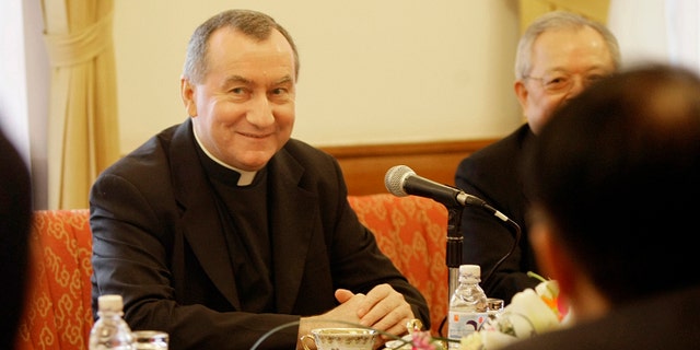FILE - In this Feb. 16, 2009 file photo Monsignor Pietro Parolin, center, smiles during a meeting in Hanoi, Vietnam. The Vatican announced Saturday, Aug. 31, 2013 that the Italian archbishop, Pietro Parolin, 58, will take up the post held since 2006 by Italian Cardinal Tarcisio Bertone, starting Oct. 15. Pope Francis has tapped a veteran Vatican diplomat to replace the Holy Seeâs secretary of state who in recent years increasingly became a divisive figure in the Catholic churchâs hierarchy. (AP Photo/Chitose Suzuki, file)