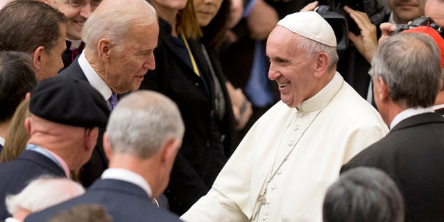 Pope Francis shakes hands with US vice president Joe Biden as he takes part at a congress on the progress of regenerative medicine and its cultural impact, being held in the Pope Paul VI hall at the Vatican, Friday, April 29, 2016. (AP Photo/Andrew Medichini)
