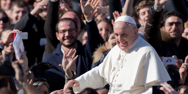 Pope Francis greets faithful as he leaves St. Peter's Square at the Vatican, Friday, Feb. 14, 2014. Pope Francis met a group of engaged couples on Valentine's Day. (AP)