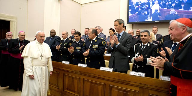 Pope Francis arrives at a conference about the human trafficking, at the Vatican, Thursday, April 10, 2014.