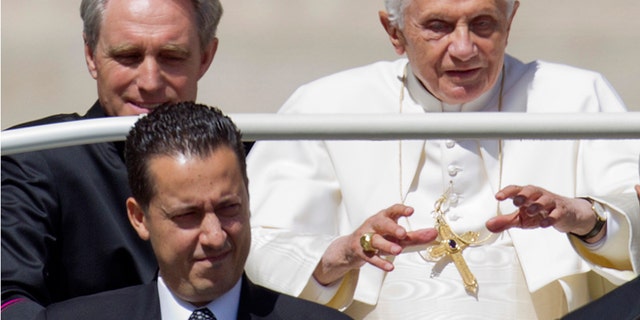 May 23, 2012: Pope Benedict XVI, flanked by his private secretary Georg Gaenswein, top left, and his butler Paolo Gabiele arrives at St.Peter's square at the Vatican for a general audience.