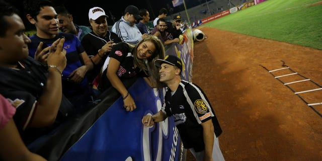 Omar Vizquel, former Cleveland Indians shortstop, poses for a photo with fans on Nov. 27, 2013 in Caracas, Venezuela.