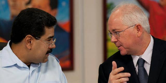FILE - In this Nov. 15, 2013, file photo, Venezuela's President Nicolas Maduro, left, speaks with his Oil Minister Rafael Ramirez before the start of a press conference at Miraflores presidential palace in Caracas, Venezuela. President Maduro has replaced on Tuesday Sept. 2, 2014, Venezuela's longtime oil minister and economic czar as part of a cabinet shakeup sidelining the most-prominent voice within his administration for much-needed reforms to address the country's economic crisis. (AP Photo/Ariana Cubillos, File)