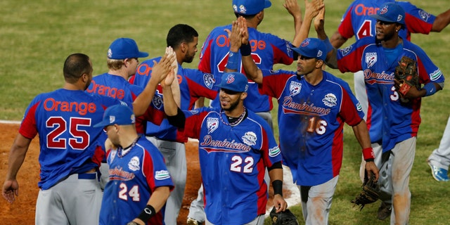 Players of the Dominican Republic celebrate after they defeated Cuba 9-2 during a Caribbean Series game in Porlamar, Venezuela, Feb. 3, 2014.