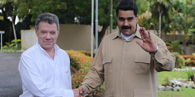 Venezuela's President Nicolas Maduro, right, and Colombian counterpart Juan Manuel Santos, in Puerto Ordaz, Venezuela, Thursday, Aug. 11, 2016.