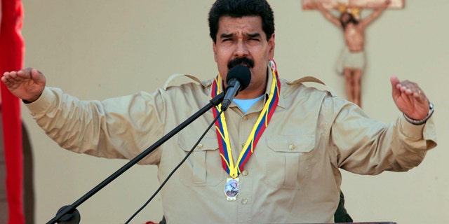 In this photo released by Miraflores Press Office, Venezuela's Nicolas Maduro speaks to soldiers inside a military base in Coro, Venezuela, Monday, Sept. 30, 2013. Maduro said Monday that his government was expelling the top U.S. diplomat in Venezuela and two other embassy employees for allegedly conspiring with the political opposition. (AP Photo/Miraflores Press Office)