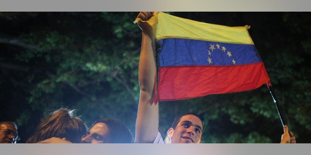 CARACAS, VENEZUELA - DECEMBER 03: Opposition supporters celebrate after defeating a referendum on changes to the Constitution proposed by Venezuelan President Hugo Chavez December 3, 2007 in Caracas, Venezuela. The tightly contested referendum proposed an elimination of term limits for Chavez and a transformation of Venezuela into a "socialist economy." Voters defeated the measures by a vote of 51 percent to 49 percent. (Photo by Mario Tama/Getty Images)