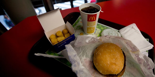 A Quarter Pounder meal is served with arepas or corn cakes at a local McDonald's, in Caracas, Venezuela, Tuesday, Jan. 6, 2015. McDonalds franchises in Venezuela have run out of potatoes and are now serving South American alternatives like deep-fried arepas or yuca, a starchy tuberous root. The franchisers are blaming a contract dispute with West Coast dock workers for halting the export of frozen fries to the country. (AP Photo/Fernando Llano)