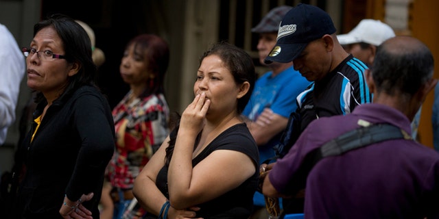 People wait in a line outside a supermarket in Caracas, Venezuela, to buy price regulated toilet paper made available for sale by the government, Friday, Jan. 22, 2016. In a note published Friday, the International Monetary Fund Western Hemisphere Director Alejandro Werner said inflation would more than double in the economically struggling South American country in 2016, reaching 720 percent. (AP Photo/Fernando Llano)
