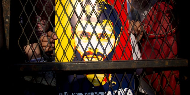 FILE - In this Feb. 20, 2016 file photo, supporters of Venezuela's jailed opposition leader Leopoldo Lopez hold posters of him during a protest demanding the release of Lopez and other jailed opposition leaders, on the second anniversary of his imprisonment, in Caracas, Venezuela. Spain's former Prime Minister Jose Luis Rodriguez Zapatero had a surprise jailhouse meeting with Lopez on June 4, 2016. It's the first time an outside visitor besides Lopez's family or lawyers have met with Lopez in the military prison where he's been held for over two years. (AP Photo/Ariana Cubillos, File)