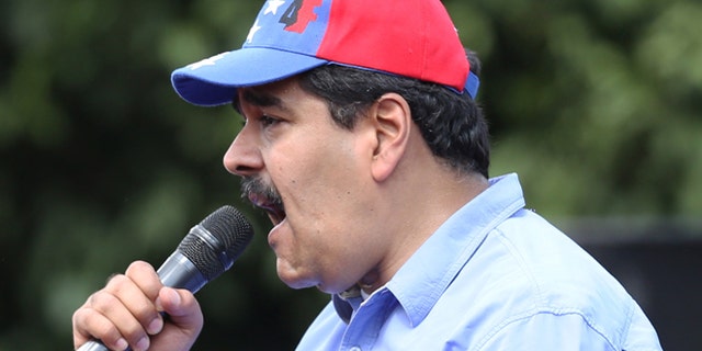 Venezuelas President Nicolas Maduro speaks to supporters during a rally to commemorate the end of Marcos Perez Jimenez's dictatorship 57 years ago, in Caracas, Venezuela, Friday, Jan. 23, 2015. President Maduro spoke against the planned visit by the ex-presidents, Andres Pastrana of Colombia, Felipe Calderon of Mexico and Sebastian Pinera of Chile, saying that the three men are coming to Venezuela to support a right wing coup against the government. (AP Photo/Ariana Cubillos)