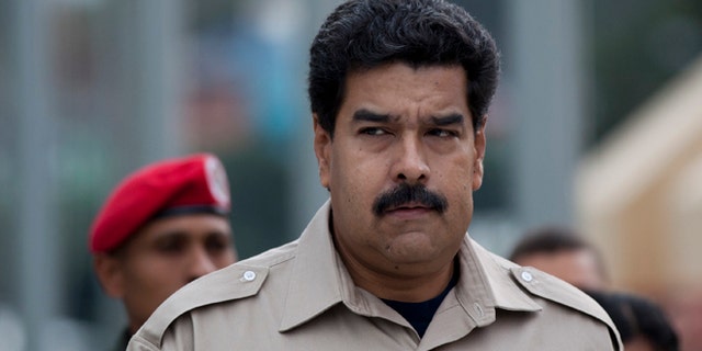 President Nicolas Maduro arrives at the Military Museum to visit the tomb of the late President Hugo Chavez in Caracas, Venezuela, Tuesday, Nov. 5, 2013. Maduro's decree establishing Dec. 8 as a public holiday in honor of Chavez was announced Tuesday. The holiday will commemorate Chavez's final public appearance, when the cancer stricken leader anointed Maduro as his successor. (AP Photo/Ariana Cubillos)
