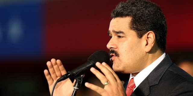 Venezuela’s President Nicolas Maduro, delivers his speech during the new military chief's swearing-in ceremony at the Fort Tiuna military base in Caracas, Venezuela, Monday, Oct. 27, 2014. (AP Photo/Ariana Cubillos)