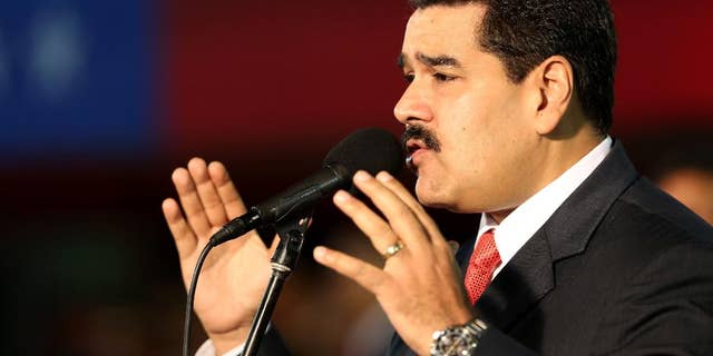 Venezuela’s President Nicolas Maduro, delivers his speech during the new military chief's swearing-in ceremony at the Fort Tiuna military base in Caracas, Venezuela, Monday, Oct. 27, 2014. (AP Photo/Ariana Cubillos)