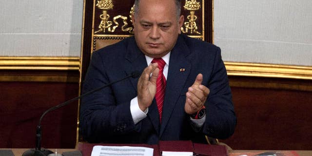 FILE - In this Jan. 5, 2013 file photo, National Assembly President Diosdado Cabello applauds before addressing the National Assembly in Caracas, Venezuela. Cabello said on Wednesday, May 13, 2015 he is asking courts to bar news executives from leaving the country while he’s suing them for alleged defamation. (AP Photo/Ariana Cubillos, File)