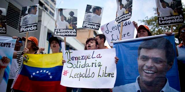 Sept. 10, 2015: People chant slogans in support of jailed opposition leader Leopoldo Lopez, outside the courthouse in Caracas, Venezuela. (AP Photo/Ariana Cubillos)