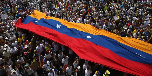 CARACAS, VENEZUELA - MARCH 02: Thousands of protesters march in one of the largest anti-government demonstrations yet on March 2, 2014 in Caracas, Venezuela. Venezuela has one of the highest inflation rates in the world, and opposition supporters have protested for almost three weeks, virtually paralyzing business in much of the country. (Photo by John Moore/Getty Images)