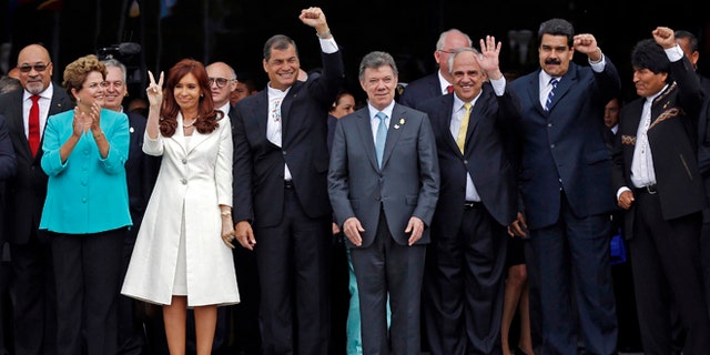 FILE - In this Dec. 5, 2014 file photo, UNASUR leaders pose for a group photo at the inauguration of the new UNASUR headquarters building in Quito, Ecuador. From left to right are Suriname's President Desi Bouterse, Brazil's President Dilma Rousseff, Argentina's President Cristina Fernandez, Ecuador's President Rafael Correa, Colombia's President Juan Manuel Santos, UNASUR General Secretary and former Colombian President Ernesto Samper, Venezuela's President Nicolas Maduro, and Bolivia's President Evo Morales. The South American regional bloc did attempt to mediate between the Venezuelan government and the opposition last year. But that effort fell through, and observers see those leaders as loath to try again. (AP Photo/Dolores Ochoa, File)