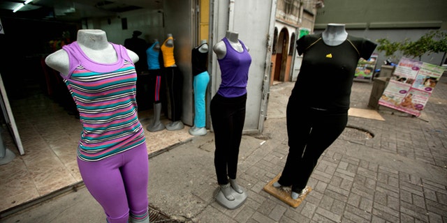 Mannequins stand at a store that sells clothing for over weight people in downtown Caracas, Venezuela, Tuesday, Aug. 26, 2014. The Venezuelan government has launched a public relations campaign to halt a steady rise in obesity that, if left unchecked, threatens to lead to a costly, public health crisis. (AP Photo/Fernando Llano)