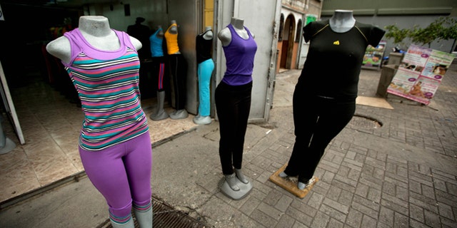 Mannequins stand at a store that sells clothing for over weight people in downtown Caracas, Venezuela, Tuesday, Aug. 26, 2014. The Venezuelan government has launched a public relations campaign to halt a steady rise in obesity that, if left unchecked, threatens to lead to a costly, public health crisis. (AP Photo/Fernando Llano)