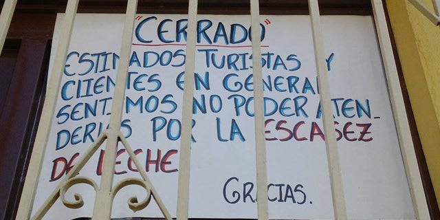 Sign outside Coromoto ice cream shop in Venezuela reads: "Dear tourists and general clients, we apologize of being unable to serve you due to the lack of milk.”