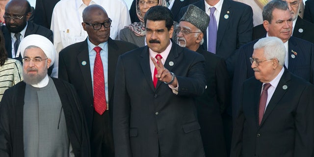 Iran's President Hassan Rouhani, front row, from left, Venezuela's President Nicolas Maduro, and Palestinian President Mahmoud Abbas, gather for an official group photo at the 17th Non-Aligned Movement Summit in Porlamar, on Venezuela's Margarita Island, Saturday, Sept. 17, 2016. (AP Photo/Ariana Cubillos)